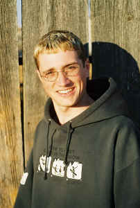 With glasses in front of the back corral.